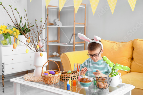 Cute little boy painting Ea...