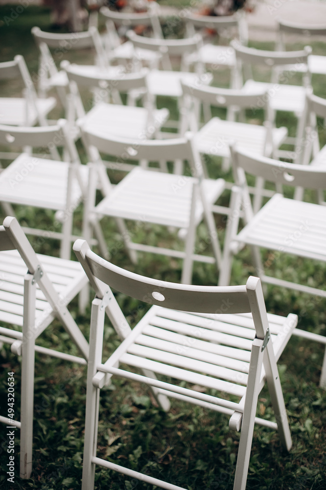 wedding ceremony preparation, wooden folding chairs