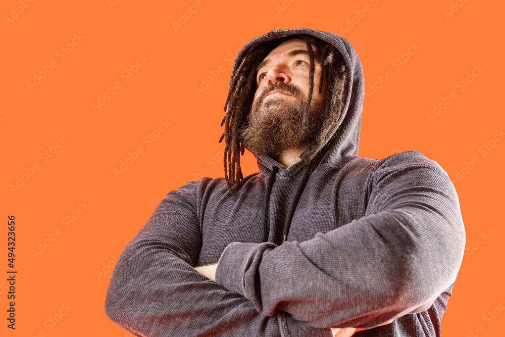 Menacing appearance. A dangerous man with a mohawk and dreadlocks covered with a hood. A middle-aged man with a beard and an unusual hairstyle Menacing appearance. A dangerous man with a mohawk and dreadlocks covered with a hood. A middle-aged man with a beard and an unusual hairstyle