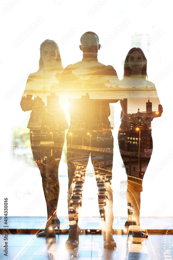 Fototapeta premium Our ideas shape the city. Shot of a city superimposed over a portrait of three ambitious businesspeople posing in the office.