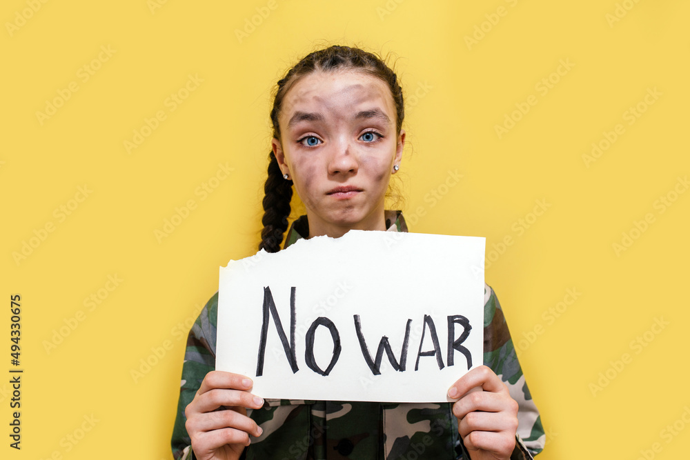 Ukrainian girl kid in military uniform with dirty face protesting war conflict raises banner with inscription massage text Ukrainian girl kid in military uniform with dirty face protesting war conflict raises banner with inscription massage text