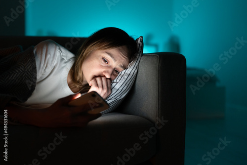 Obraz na plátně Depressed sleepless young woman follow cheating ex-boyfriend in social media lying tired in bed and suffering from insomnia
