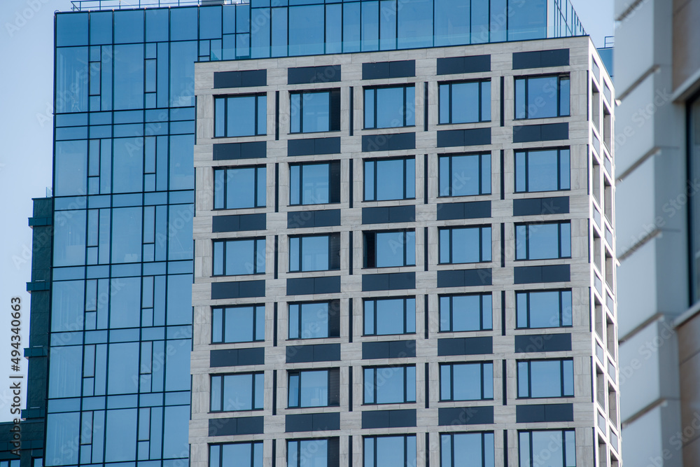 cropped part of skyscraper building with blue sky cropped part of skyscraper building with blue sky