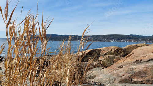 Photography Oslo fjord beach in Krokstrand with blue water against blue sky