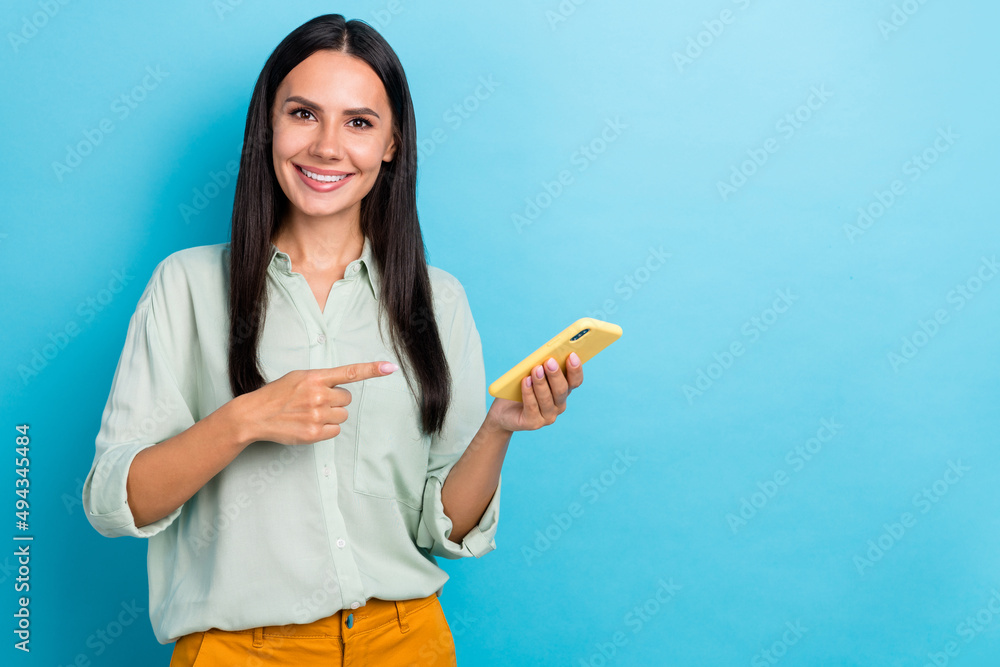 Photo of good mood pretty lady advertise product on black friday recommend new phone isolated on blue color background