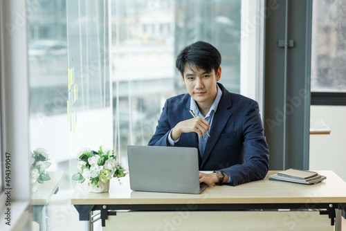 Portrait of a successful entrepreneur at cozy home office, smiling at camera.