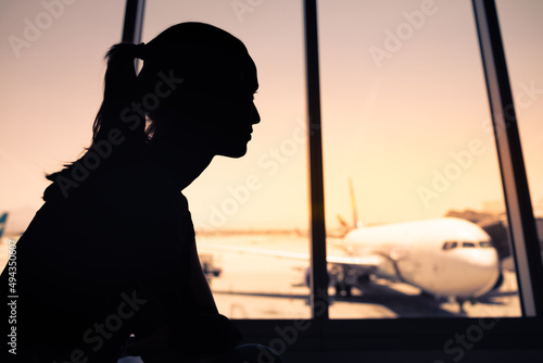 silhouette of a young female sitting airport  photo