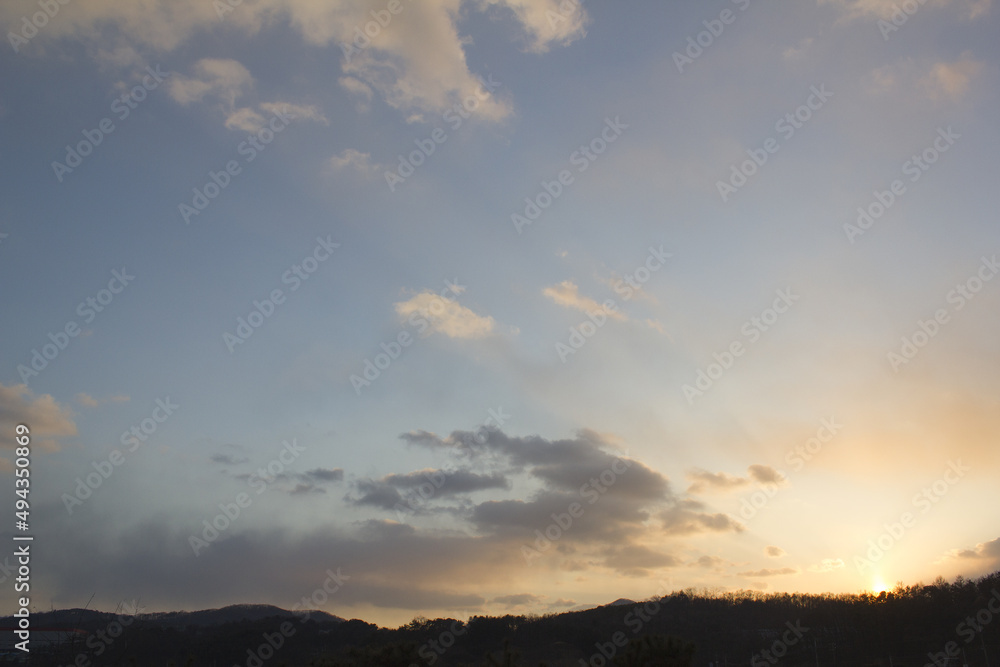 cloud and vanilla sky background with dark mountain silhouette