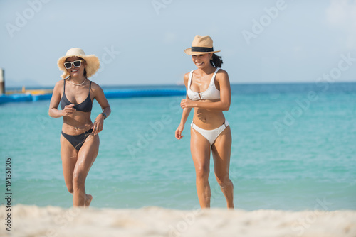 two people on the beach. Two woman having fun in the sea.