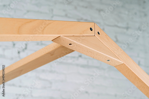 The image of the child's bed, plank joints, details against the backdrop of the white ceiling.