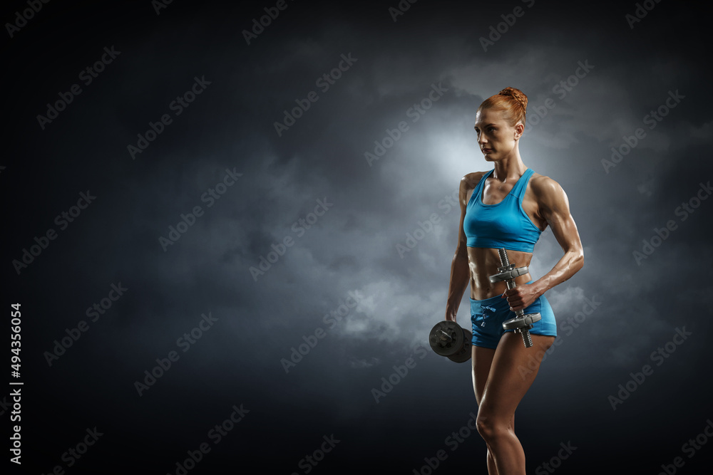 Obraz premium Young beautiful girl doing exercise against dark background . Mixed media