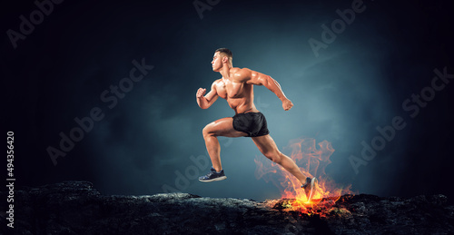 Male runner against dark background . Mixed media © Sergey Nivens