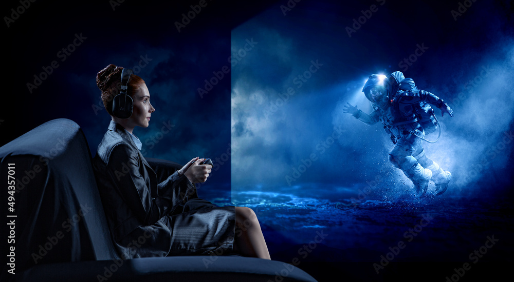 Passionate female gamer with controller . Mixed media Passionate female gamer with controller . Mixed media