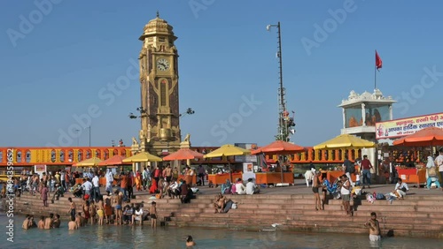 Haridwar, Uttarakhand, India - 10th April 2021 : Hindu devotees bathing in Har Ki Pauri Ghat, Holy river Ganges, on the occassion of Kumbh Mela. Ritual is called shahi snan, shaahi snan or Kumbh snan. photo