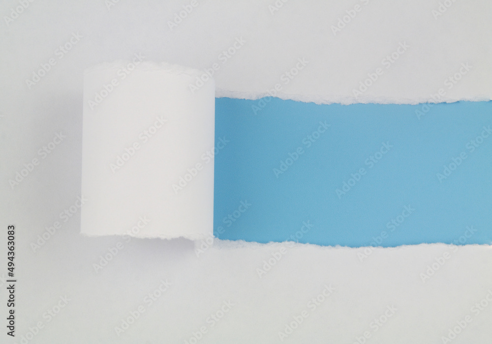 Torn white paper with blue background. Copy space for text. Torn white paper with blue background. Copy space for text.