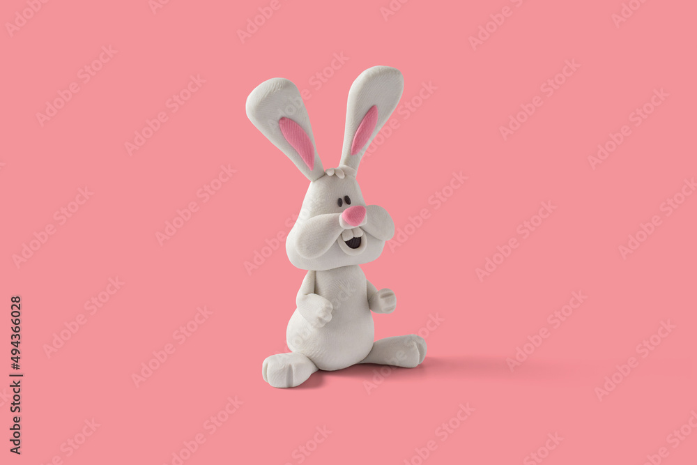 Easter bunny design handmade with plasticine on a pink background Easter bunny design handmade with plasticine on a pink background
