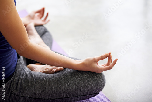 Fototapeta Naklejka Na Ścianę i Meble -  Finding inner peace. Cropped shot of a woman practicing yoga at home.