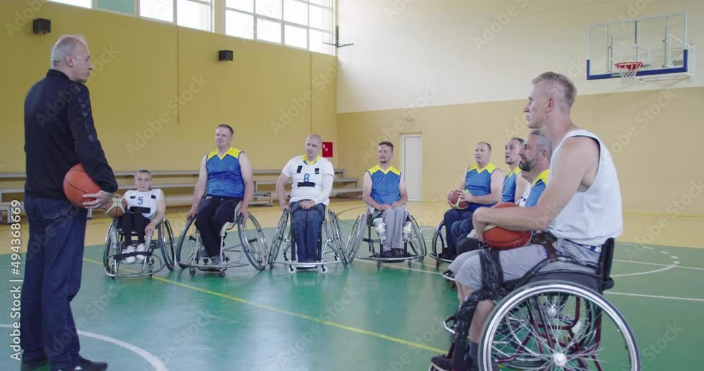 selector I explain new tactics to basketball players in wheelchairs, persons with disabilities sitting in wheelchairs listening to the selector selector I explain new tactics to basketball players in wheelchairs, persons with disabilities sitting in wheelchairs listening to the selector