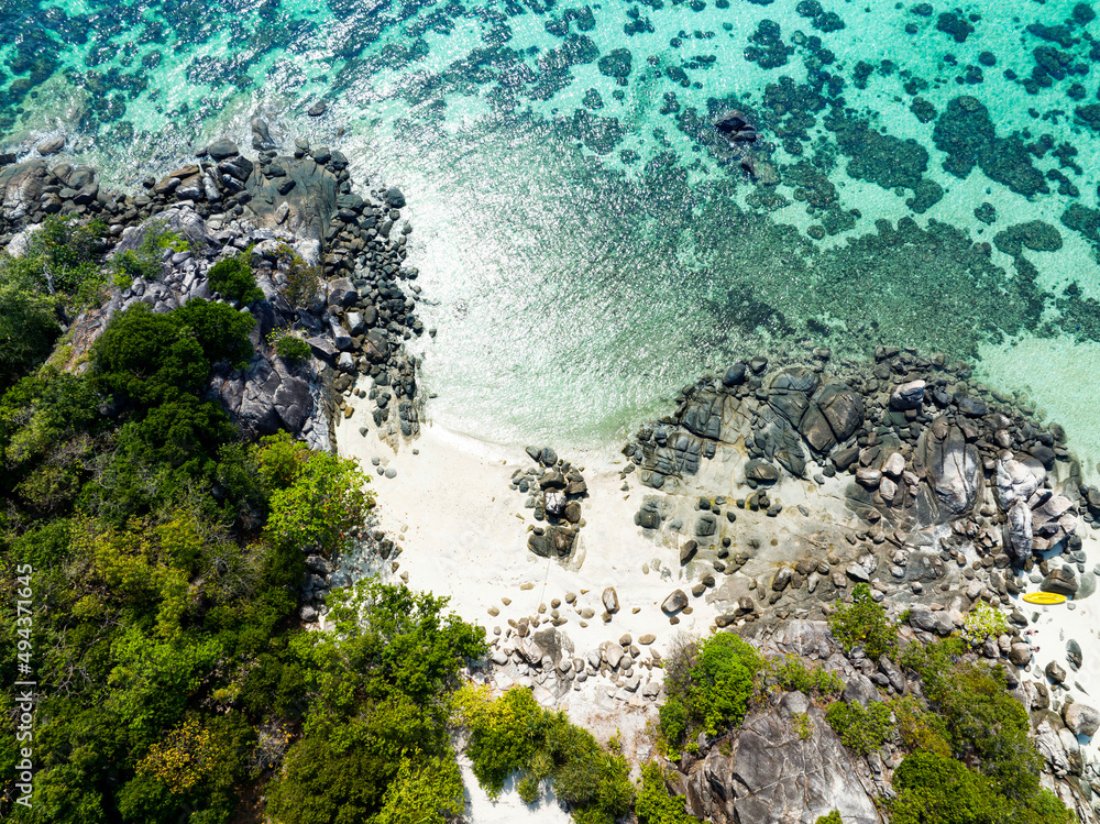 Aerial top view  of Isolated beautiful tropical island with white sand beach and blue clear water and granite stones