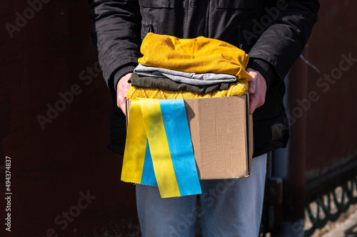 Close up of volunteer carrying box with Humanitarian aid for Ukrainian refugees in street © sokorevaphoto