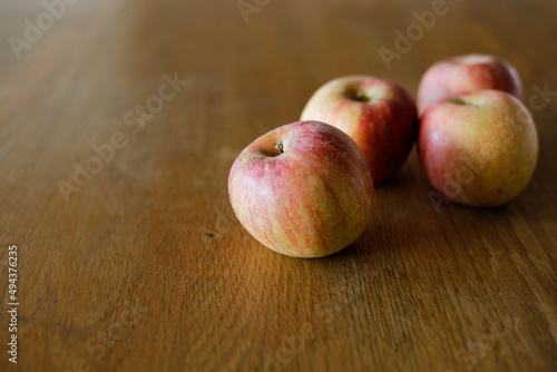 Fuji apples on wooden dining table. Space for copy.