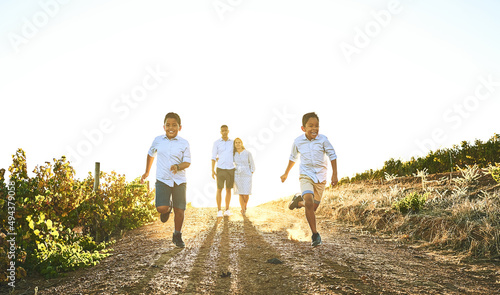 Running along to a day of fun. Shot of a happy family bonding together outdoors. © Ruan J/peopleimages.com