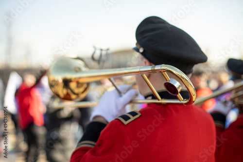 Trumpeter in Russia. Military band. Musical instrument. Guy blows pipe. photo