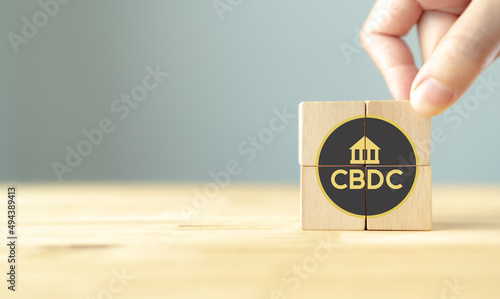 CBDC Central Bank Digital Currency. Financial technology,blockchain, matchine learning, exchange, money and digital asset. Futuristic financial ,investment market. Putting wooden cubes with CBDC icon. photo