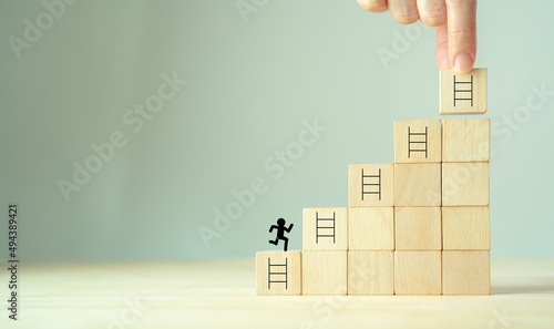 Strategies and success concept. Rises up stairs to goal, achieve business success. Personal growth. Initiation for planning to reach target. Take action icons on wooden cubes with grey background.