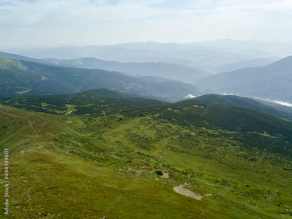 High mountains of the Ukrainian Carpathians in cloudy weather. Aerial drone view.