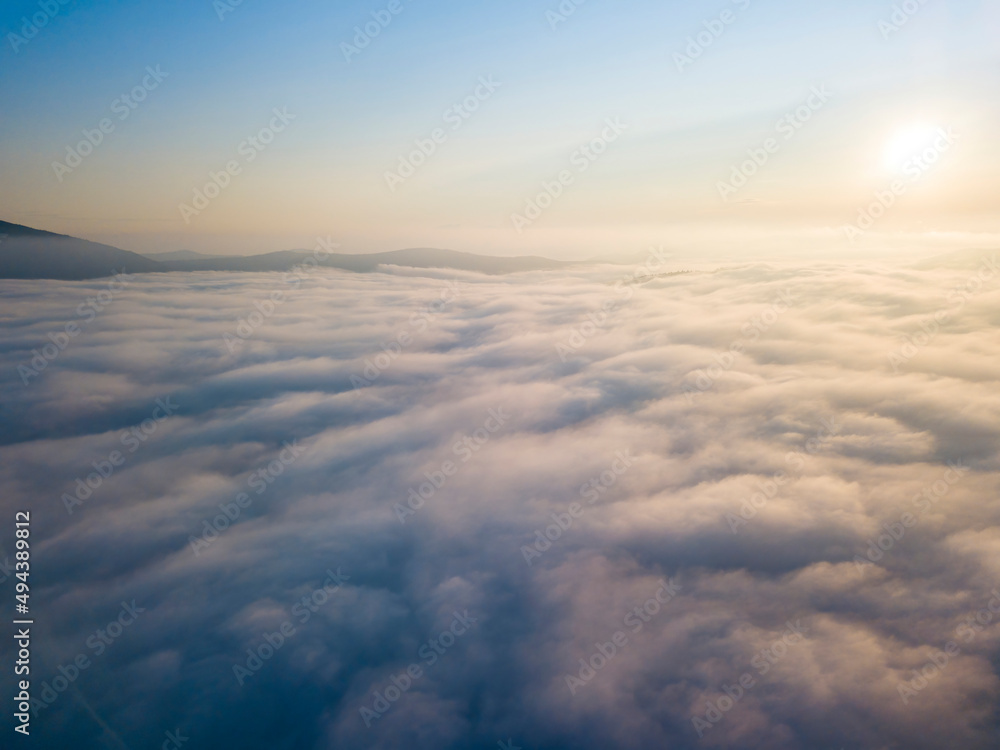 High flight above the clouds. Aerial drone view.