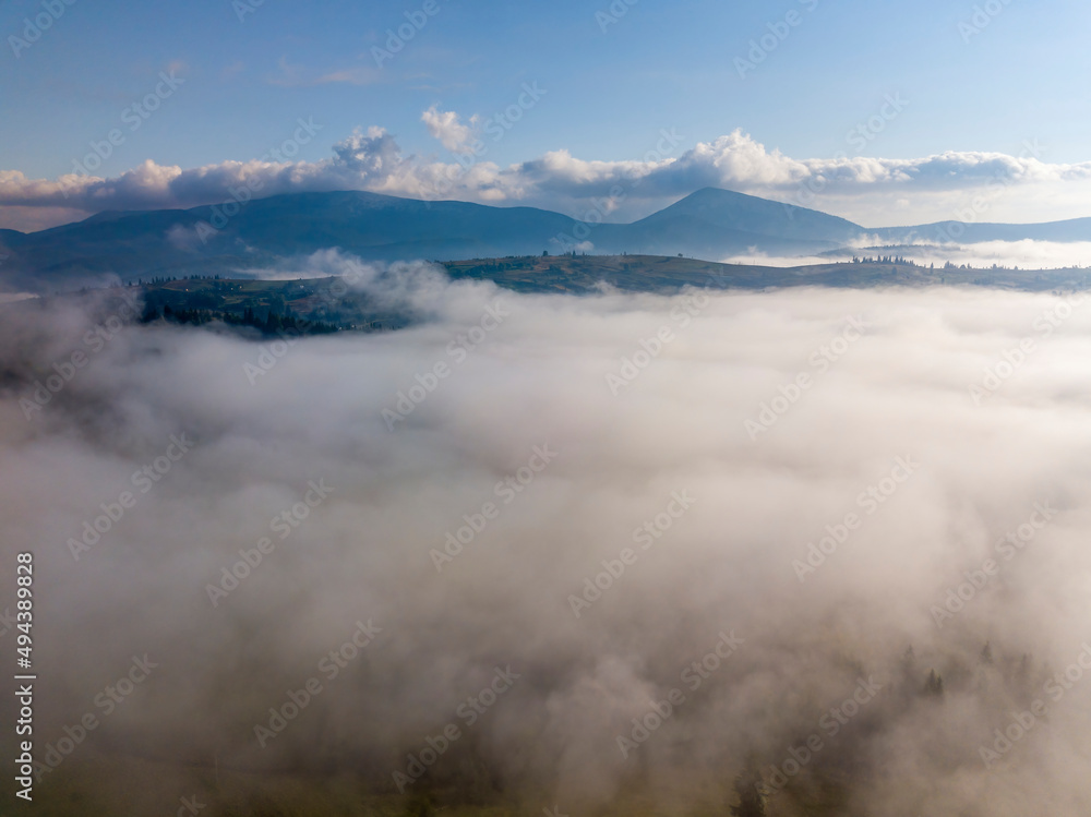 Morning fog in the Ukrainian Carpathians. Aerial drone view.