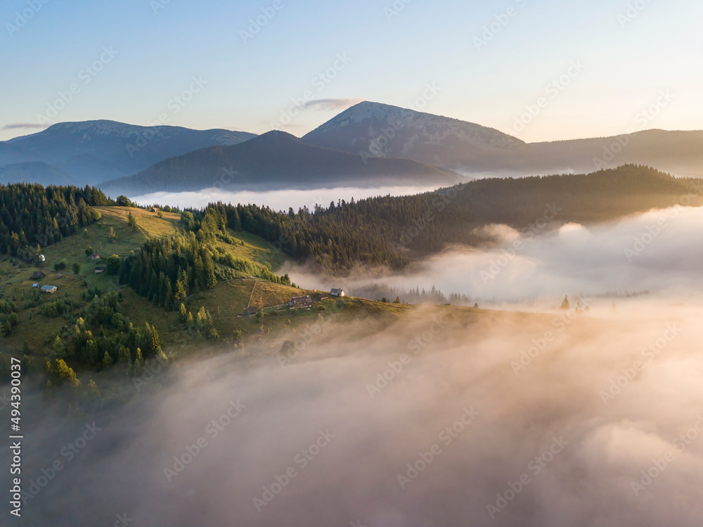 Sunrise over the fog in the Ukrainian Carpathians. Aerial drone view. Sunrise over the fog in the Ukrainian Carpathians. Aerial drone view.