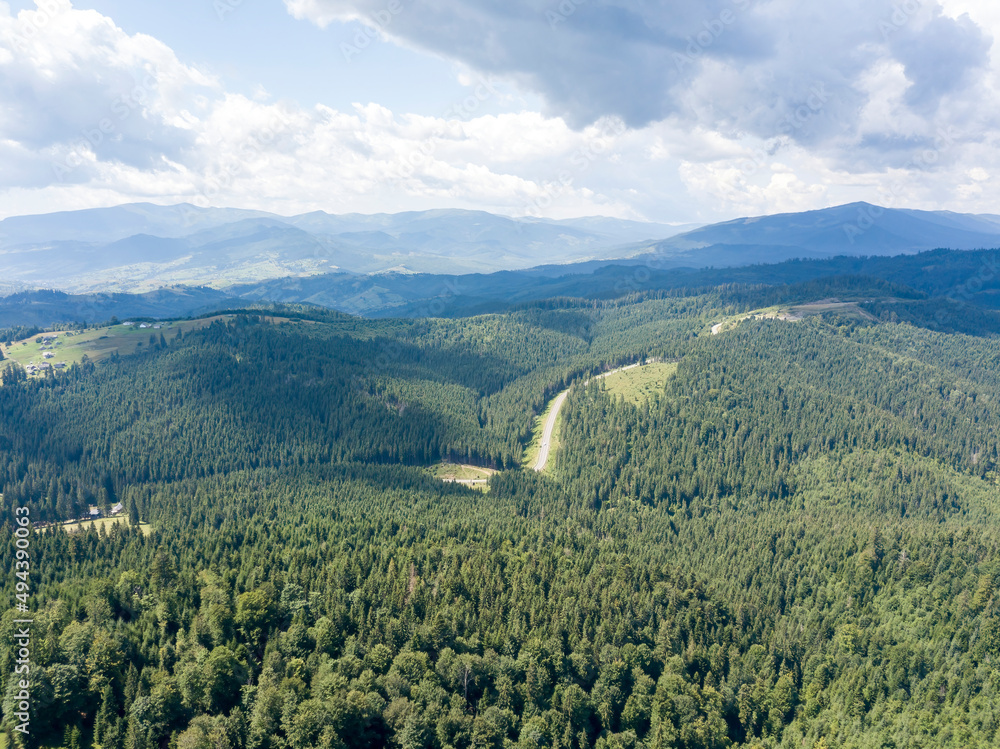 Green mountains of Ukrainian Carpathians in summer. Sunny day. Aerial drone view.