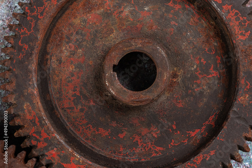 Part of the old mechanism is a metal gear covered with rust on a close-up textural background. Technical concept with copy space, horizontal orientation, top view