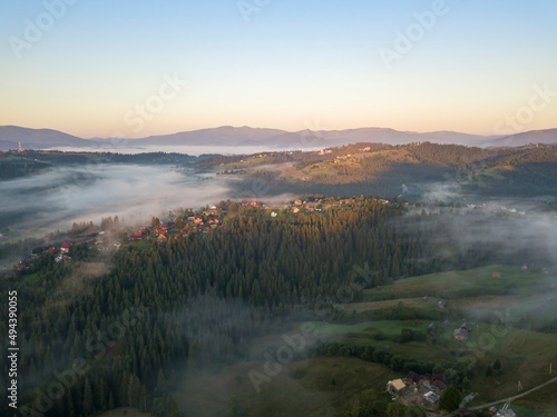 Fototapeta Naklejka Na Ścianę i Meble -  Green mountains of the Ukrainian Carpathians in the morning mist. Aerial drone view.