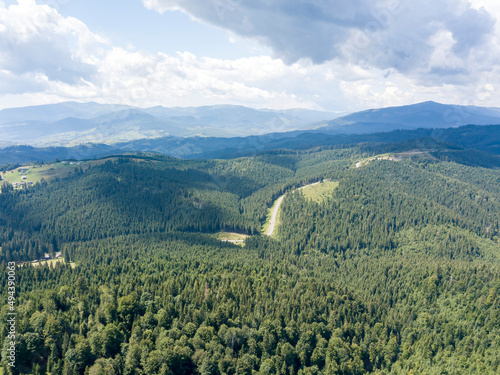 Green mountains of Ukrainian Carpathians in summer. Sunny day. Aerial drone view.