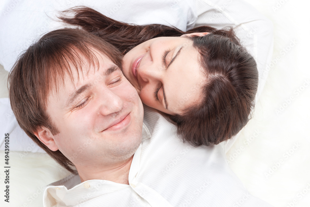 Family Ideas. Caucasian Loving Happy Couple Posing With Heads Turned to Each Other Closely Together Over White Background. Family Ideas. Caucasian Loving Happy Couple Posing With Heads Turned to Each Other Closely Together Over White Background.