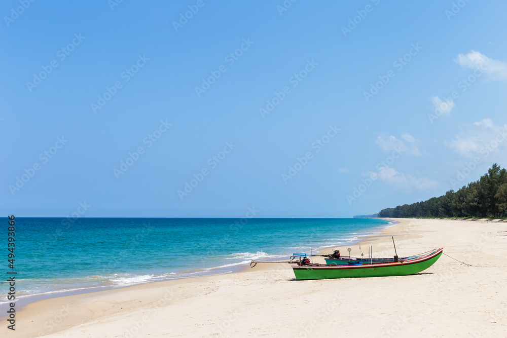 Wooden fishing boat on beautiful beach in south of Thailand, tropical island, summer holiday destination in Asia