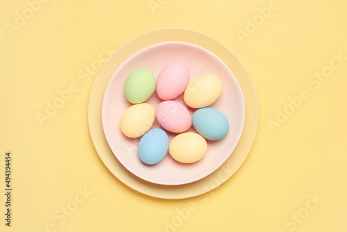 Easter colored pastel eggs on the plate  holiday card