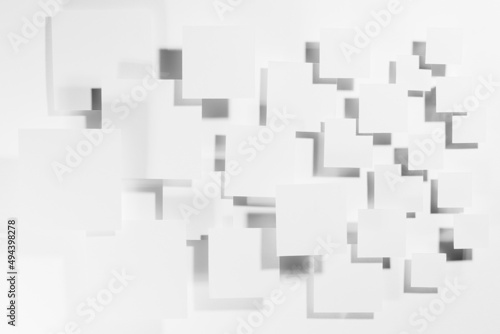 White abstract geometric background with flying paper squares in bright light with dark gradient pockmarked shadows, top view. Simple mosaic pattern in minimalist style.