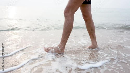 4K 25fps Slow Motion, Close-up of feet walking comfortably on the beach, with gentle waves hitting your feet, feeling refreshed and cool, popular tourist attraction