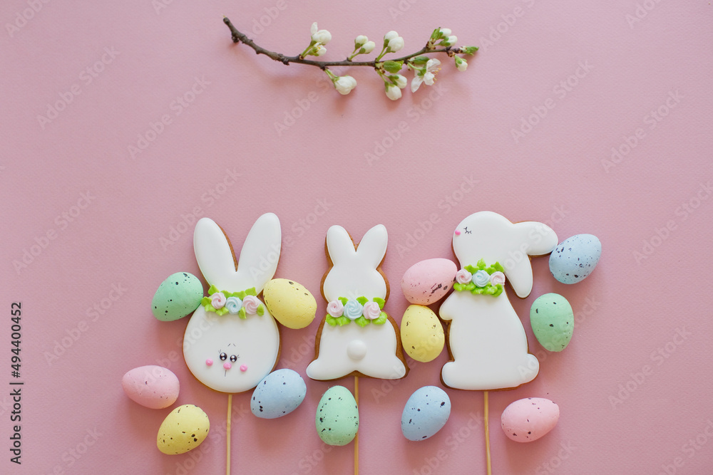 Easter cookies and eggs pink background
