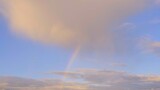 Multicolored rainbow and clouds in the sky after the rain, abstraction, blurred