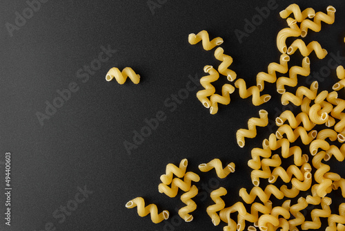 Raw pasta cavatappi with copy space on black background. photo