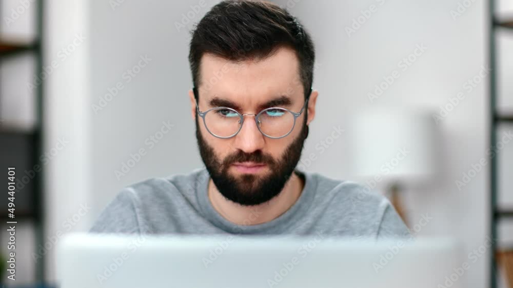 Confident business man working use laptop browsing internet searching information at home office Confident business man working use laptop browsing internet searching information at home office