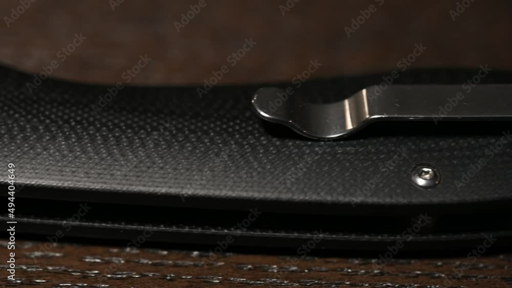 slide over a high-end tactical folding knife with composite handle, thumb opener and ball bearing pivot, and pocket clip, sliding right to left slide over a high-end tactical folding knife with composite handle, thumb opener and ball bearing pivot, and pocket clip, sliding right to left
