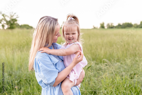 Mother with a toddler daughter hugging enjoing outdoors in summer. Happy family portrait. Spending family time together. Single parent. © Rodica