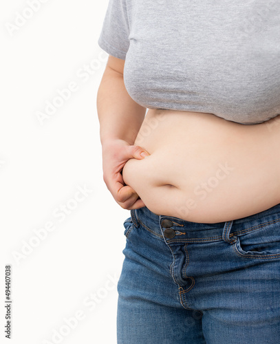 Close up of a obese young woman checking her fats