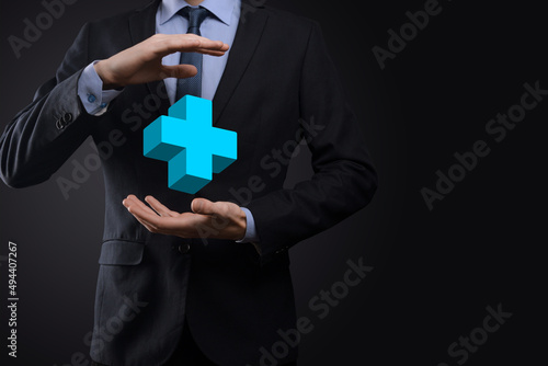 Fototapeta Naklejka Na Ścianę i Meble -  Businessman hold 3D plus icon, man hold in hand offer positive thing such as profit, benefits, development, CSR represented by plus sign.The hand shows the plus sign